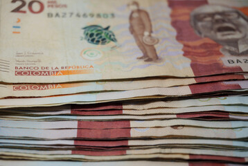 Stack of Colombian 20000 pesos bills background	