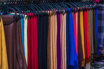 A colorful display of scarves on a rack in a retail shop in Istanbul, Turkey