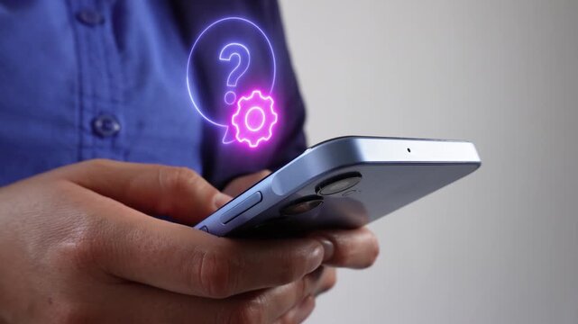 Business person with a smartphone and a virtual floating question mark icon with a gear. Customer service and problem resolution. - Powered by Adobe