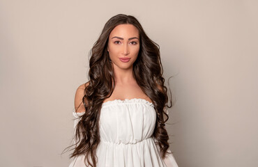 Fototapeta premium Beautiful young woman with long black shiny hair 
