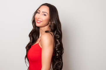 Fototapeta premium Beautiful young woman with long black shiny hair 