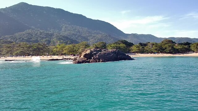 Beautiful landscape of Cachada&ccedil;o Beach (Praia do Cachada&ccedil;o) in Trindade, Rio de Janeiro. This tropical paradise shows the turquoise sea, sandy shore, and lush Atlantic Forest mountains.