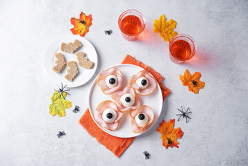 Halloween appetizer with eggs, black olives and ham in the form of eyes