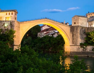 Stone arch bridge at twilight over river