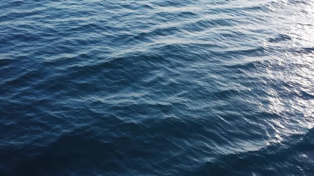 Gentle Ocean Waves Creating Abstract Patterns, Blue Sea Surface Texture for Backgrounds and Design