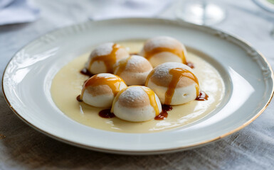 A photograph of a classic French dessert "L'&icirc;le flottante" presented on a pristine white porcelain plate. 