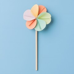Pastel Rainbow Paper Pinwheel on Blue Background