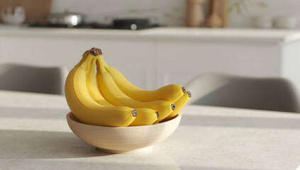 Ripe yellow bananas in a light wooden bowl sit on a kitchen counter.