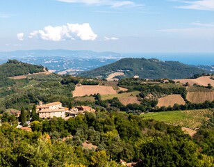 Fototapeta premium Panoramic view of Italian countryside with villages, hills, vineyards, and coastline
