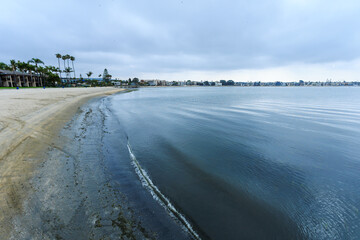 West and north shoreline of Sail Bay with sandy beaches and vacation rental homes in summer, San Diego, California