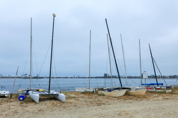 Catamarans and other vessels on a sand of boat beaching area of Sail bay, San Diego, California