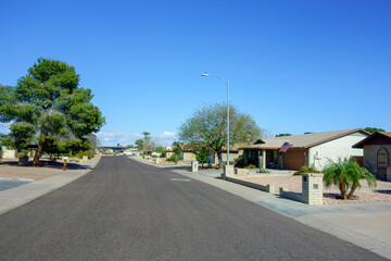 Quiet cul-de-sac at the end of residential street with single-store houses in a well-maintained xeriscaped community of major Arizona capital city of Phoenix