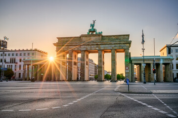 The Brandenburg Gate with sunrise flare in Berlin. Germany