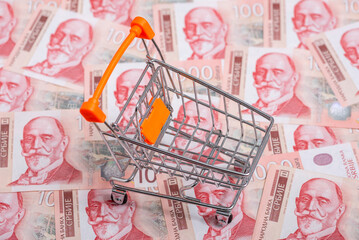 Shopping cart on a pile of Serbian paper money