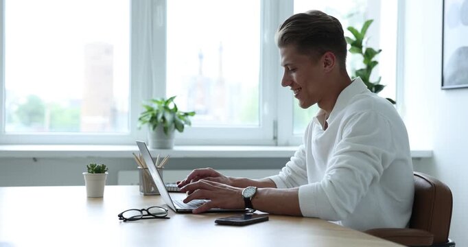 Copywriter using laptop at wooden table indoors