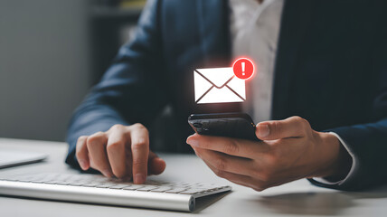 Businessman checking urgent email notification on smartphone at office desk