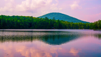 Tranquil Vermont summer sunset landscape over Kettle Pond in Groton State Forest, a kettle hole lake formed by glacial ice, surrounded by Owl’s Head Mountain and the Green Mountains.