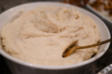 Creamy, fluffy mashed potatoes served in a white bowl, perfect for pairing with a variety of dishes...