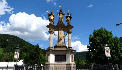 Golden Trinity Column in Austria against a backdrop of blue sky and fluffy clouds