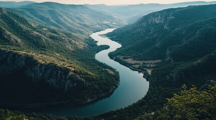 Dramatic river valley landscape with winding river cutting through mountains