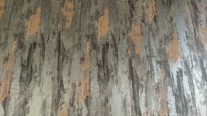 Rough, layered stone texture with grey and orange hues.	
