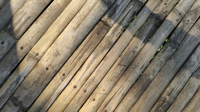 Full frame shot bamboo sticks, Bamboo wall Background, Close-Up of Rustic Woven Bamboo Texture. Old yellow amboo patterns for natural background.	
