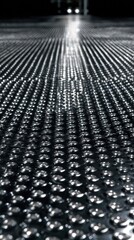 Close-up view of a patterned metal floor.  Light streaks towards the center