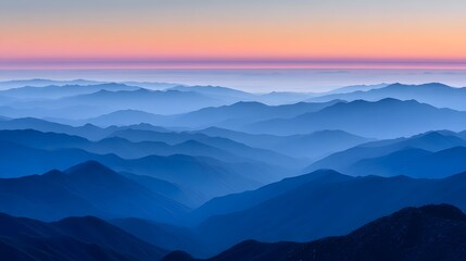 Fototapeta premium A vista of layered mountains at sunrise.
