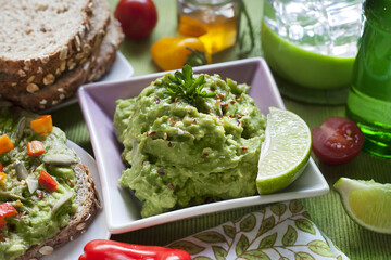 Creamy guacamole with lime, whole grain bread, and colorful toppings—perfect for healthy, organic, and real food lifestyle visuals