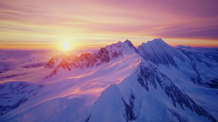Majestic sunrise over snow-capped mountain peaks.