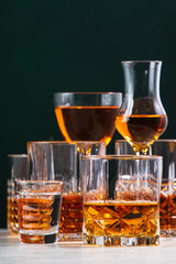 Strong alcoholic drinks set. Spirits, liqueurs, distillates etc. in glasses. Drink background banner. Hard alcohol in assortment