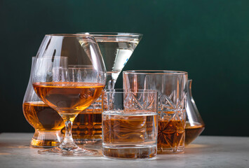 Strong alcoholic drinks set. Spirits, liqueurs, distillates etc. in glasses. Drink background...