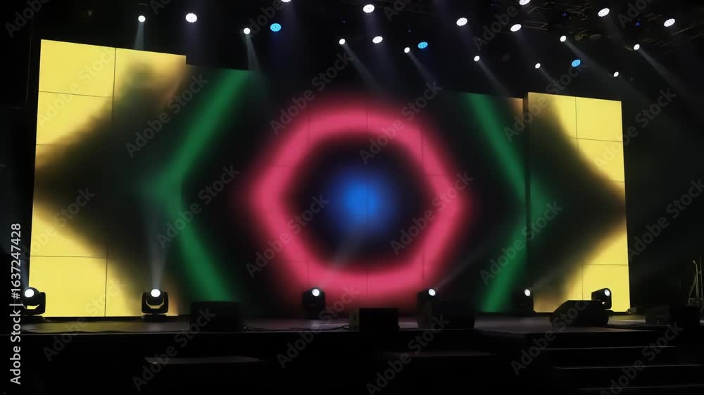 Poster stage with a large blue screen and a display with orange patterns. stage lights and speakers are vis