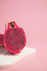 Fresh dragon fruit sliced on a light background