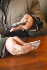 Person scan QR code with smartphone while at cafe