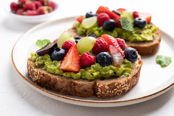 Avocado toast with strawberry, blueberry, raspberry and grape. Healthy eating