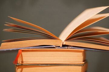 Books stacked together with pages open in a quiet setting