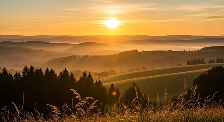 Photo of golden sunrise over the hills and fields in the countryside landscape