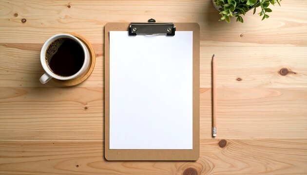 Top view of a wooden office desk with a blank clipboard, coffee, and a pencil. Workspace for business planning and creativity.