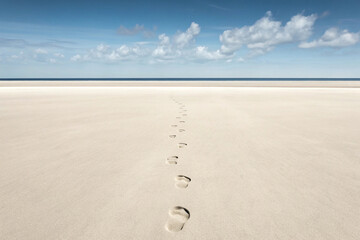 minimalist photo of footprints in beach sand