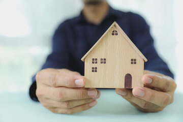 Hand choose house for financial planning or plan of money savings or for home loan management for buy housing residential or family insurance or banking agreement.