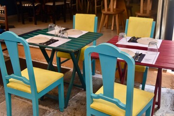 Outdoor European cafe dining tables and chairs on a cozy street in Rethymno Crete Greece