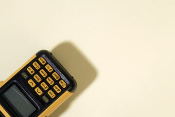 Close-up of a Walkie-Talkie Keypad and Screen on a Yellow Background