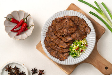 Taiwanese braised beef shank slices in a plate on white table background.