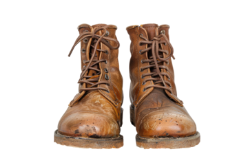 Worn brown leather lace-up boots.  Pair of used, slightly dirty,  leather work boots