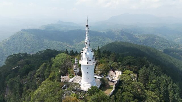 Aerial 4K drone footage of Ambuluwawa Tower, Sri Lanka. Stunning views of the iconic spiral tower, lush hills, and panoramic landscapes perfect for travel, cultural, and architectural projects.
