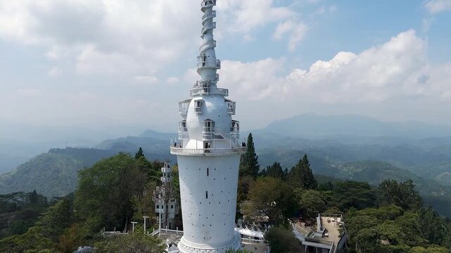 Aerial 4K drone footage of Ambuluwawa Tower, Sri Lanka. Stunning views of the iconic spiral tower, lush hills, and panoramic landscapes perfect for travel, cultural, and architectural projects.
