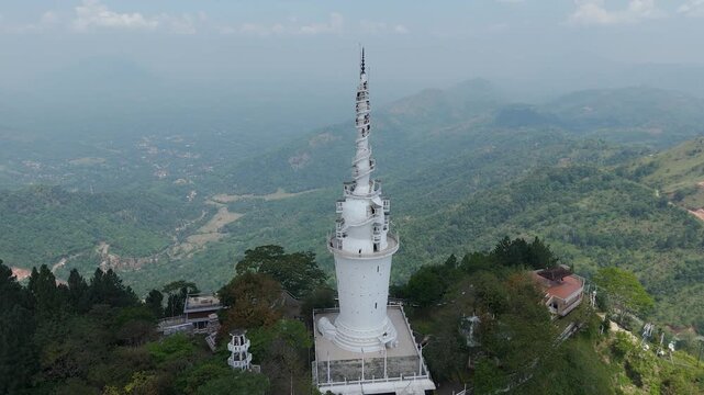 Aerial 4K drone footage of Ambuluwawa Tower, Sri Lanka. Stunning views of the iconic spiral tower, lush hills, and panoramic landscapes perfect for travel, cultural, and architectural projects.
