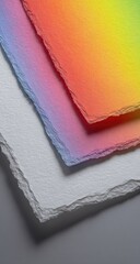 Three sheets of layered, textured paper, showcasing vibrant color gradients from rainbow hues to white