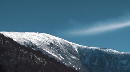 Snowy mountain ridge against a clear sky.
